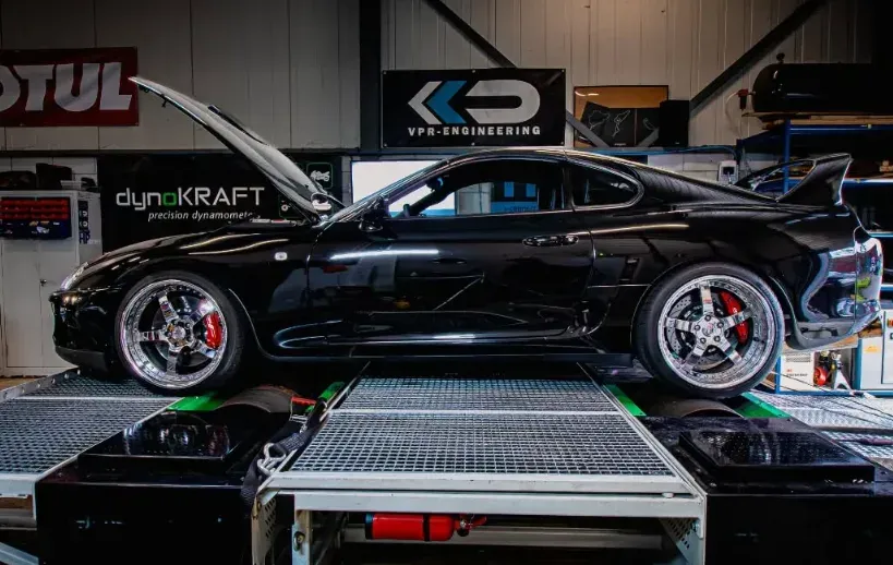 Zwarte Toyota Supra op de rollenbank van dynoKRAFT, met het VPR-Engineering bord op de achtergrond.